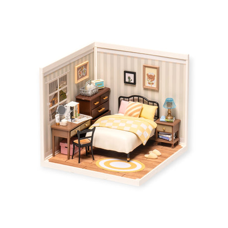 Explore the "Rolife Sweet Dream Bedroom - DIY Plastic Mini House," a miniature diorama complete with bed, desk, dresser, checkered blanket, and striped rug. It features lovely details such as wall decor, a lamp, books, and mirror—ideal for your next mini hangout project.