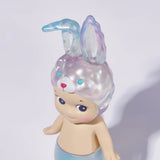 A Sonny Angel Candy Store Series plastic figurine, with a rabbit-eared hat and mermaid tail, stands against a plain background, capturing the brand's whimsical charm.
