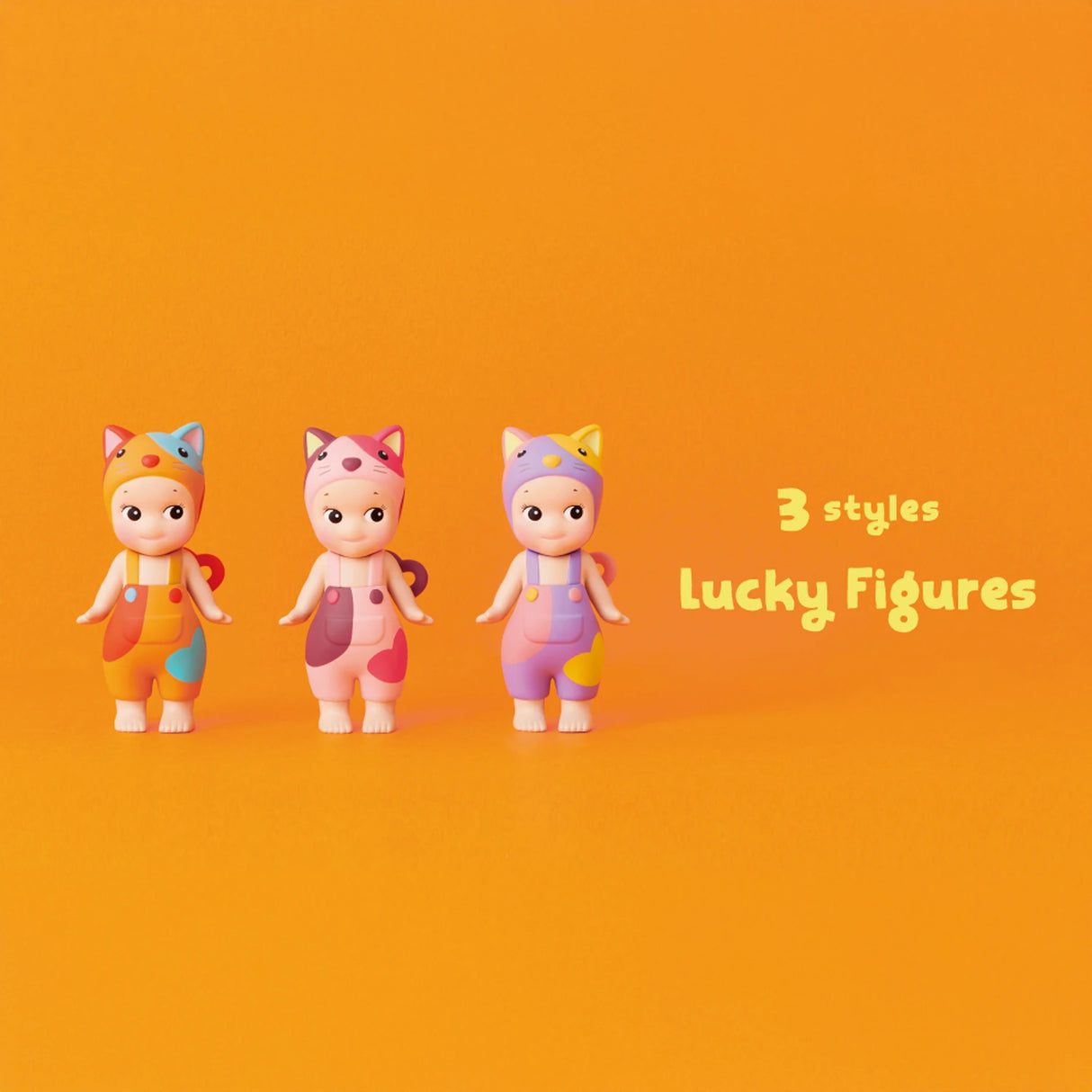 Three toy figures from the Sonny Angel Cat Life Series stand against an orange backdrop with the text "3 styles Lucky Figures." Dressed in vibrant animal-themed outfits, these limited edition figures by Sonny Angel add a playful touch to any collection.