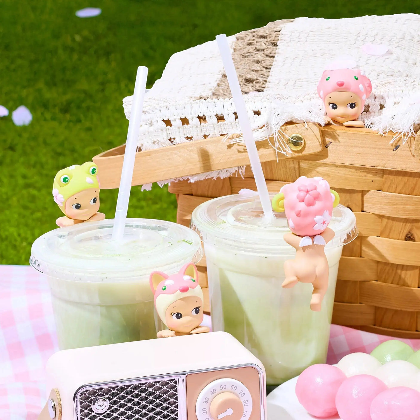 Cherry blossom bunny-hat hipper figurine standing on a drink with straw