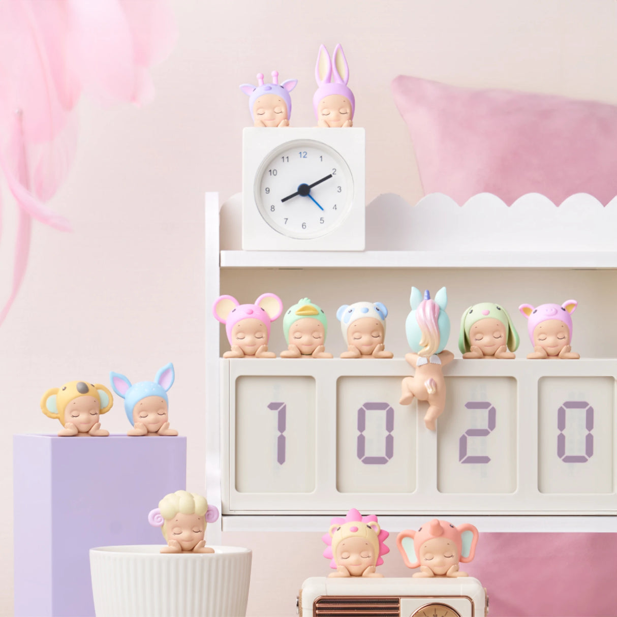 Charming figurines from the Sonny Angel Hippers Blind Box - Dreaming collection by Sonny Angel are dressed as various animals and displayed on a white shelf next to a digital clock reading "10:20," all surrounded by gentle pastel decor.