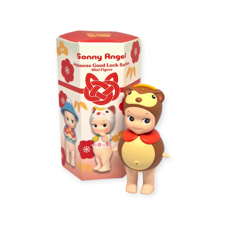 A toy figure dressed in a bear outfit stands next to a red box labeled "Sonny Angel Japanese Good Luck," exuding an aura of fortune and capturing the magical essence of Sonny Angel's world and Japanese lucky symbols.