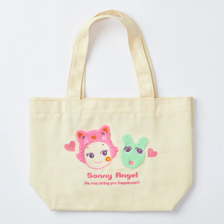 Introducing the Sonny Angel Kiss Kiss Tote Bag - Limited Edition from Sonny Angel, a beige tote featuring embroidered cartoon faces, hearts, and the text "Sonny Angel He may bring you happiness!" for a cheerful splash to any outfit.