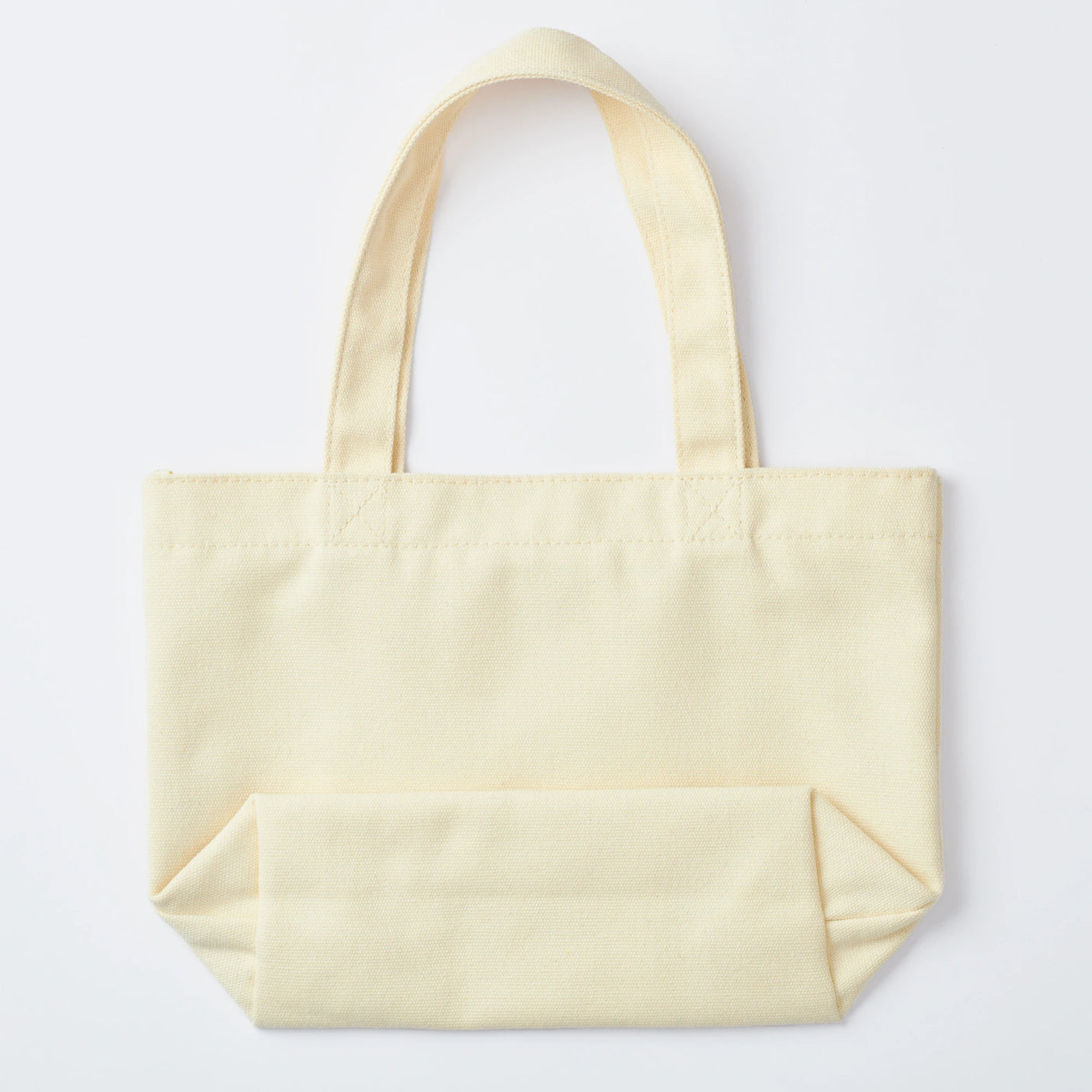 Introducing the Sonny Angel Kiss Kiss Tote Bag - Limited Edition, a plain beige tote with two handles, set against a crisp white background.