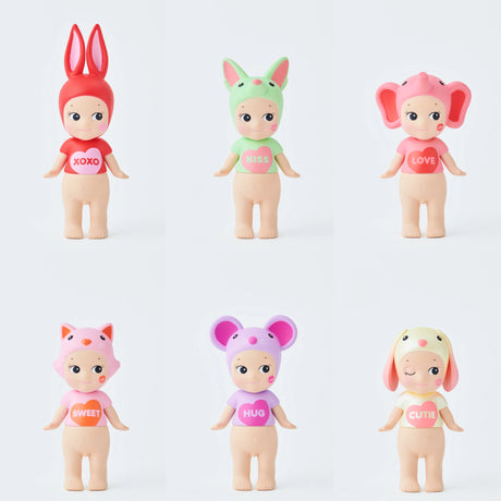 Six Sonny Angel Kiss Kiss Series dolls with animal hats and shirts: red "XOXO" rabbit, green "KISS" unicorn, pink "LOVE" elephant (top row); orange "SWEET" fox, purple "HUG" mouse, yellow "CUTIE" dog (bottom row). Ideal for a Blind Box surprise!.