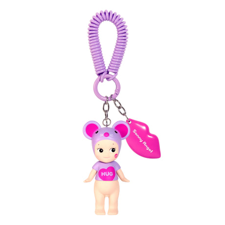 Explore a charming keychain from the Sonny Angel Kiss Kiss Series. It features a small doll in a purple mouse hat and "HUG" shirt, linked to a purple spiral band with a pink lips-shaped tag, echoing the surprise and charm of Sonny Angel's Blind Box treasures.