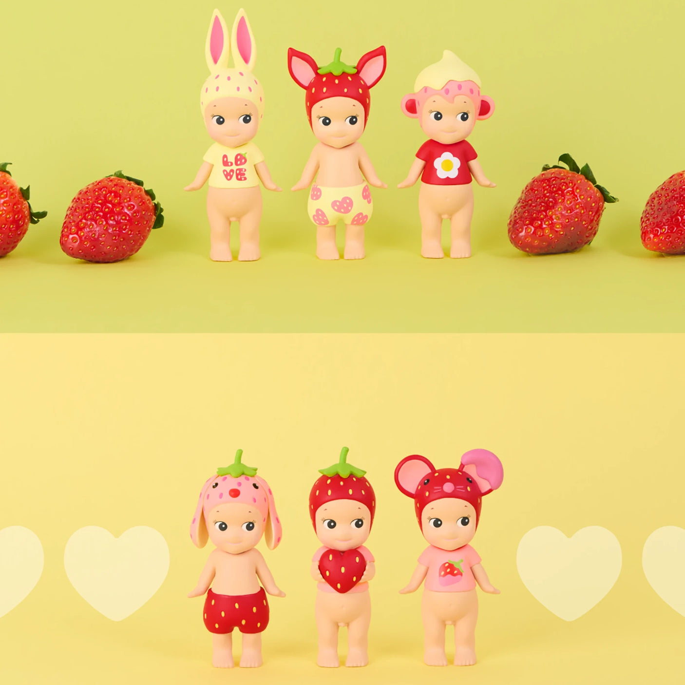 Three small dolls with animal ears and strawberry-themed outfits on a yellow background with strawberries.