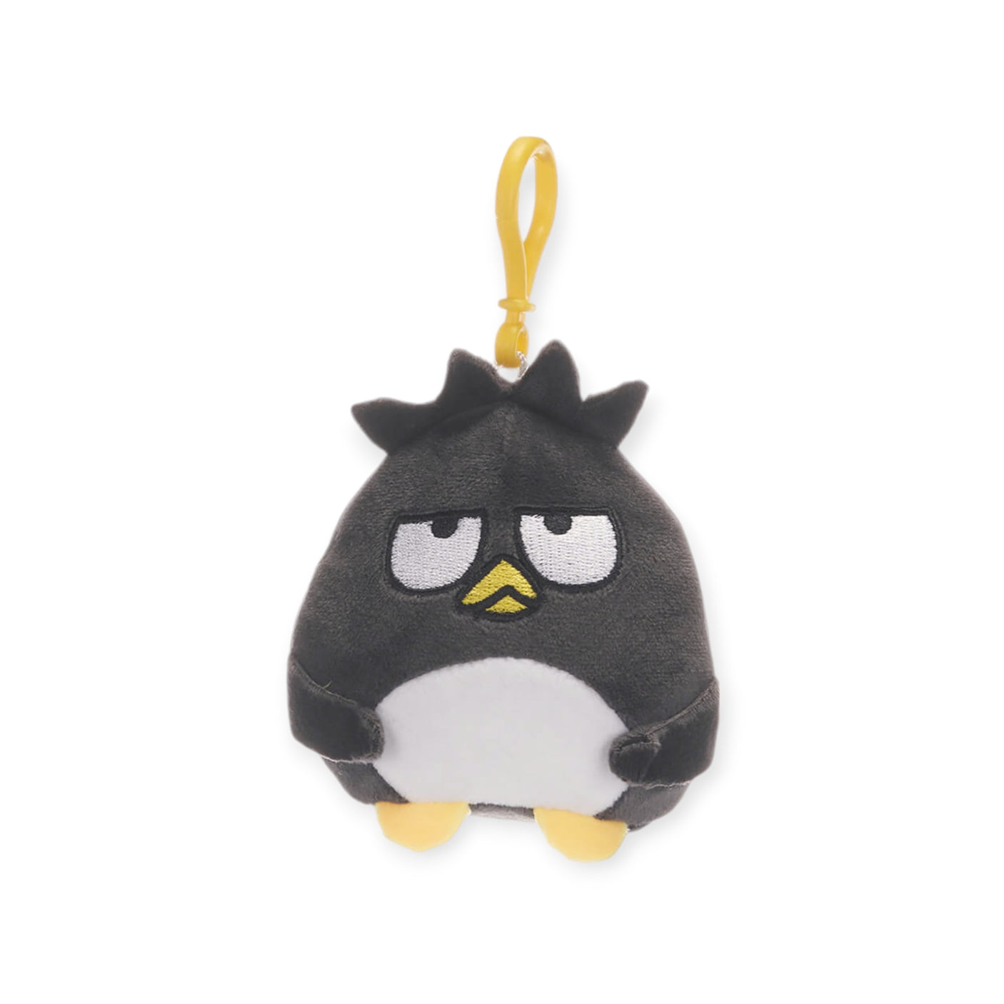 A plush keychain from the Hello Kitty & Friends collection featuring a black and white Sanrio character with a grumpy expression and a yellow hanging loop, ideal for enthusiasts of Hello Kitty keychains.