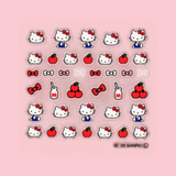 Sheet of Hello Kitty nail decals: face icons, red bows, hearts, and apple shapes