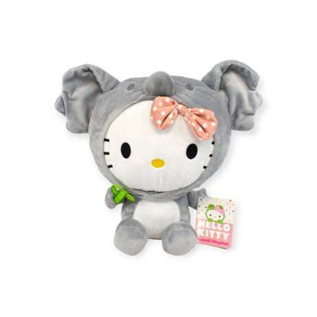 Step into the Kawaii Kingdom with this 25cm Hello Kitty plush toy, dressed as a grey elephant and adorned with a pink polka dot bow. Soft, huggable, and holding a green leaf, she's your adorable snuggle buddy.