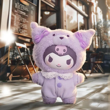 Small plush figure with a purple skull hat and cat ears standing on tiled floor with blurred café background