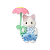 This adorable figurine from the Sylvanian Families Blind Bag - Blooming Baby Friends is dressed in a charming blue outfit, holding a delicate pink flower much like a whimsical blooming surprise.