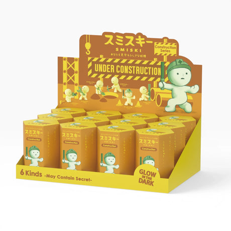 Construction figure blind box display set with yellow boxes and green character