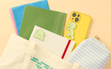 Green embroidered Smiski pushing sticker on white backing card