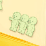 Light green embroidered character patch with three stacked cute faces and stitched details