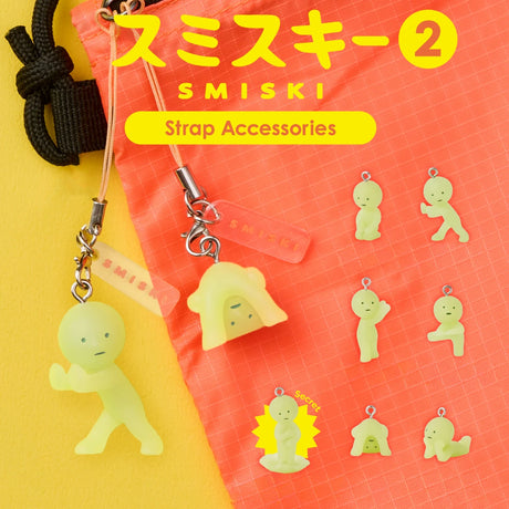 Two Smiski Strap Accessory Keychain - Series 2 items by Smiski hang from a coral bag, while eight collectible mini figures from the series are displayed on a yellow background, with Japanese and English text above.