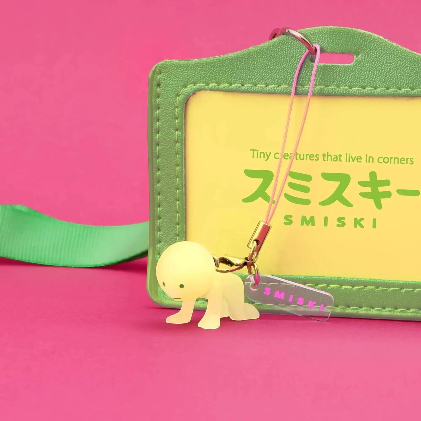 Mint green Smiski strap keychain with clip attached to stitched leather pouch