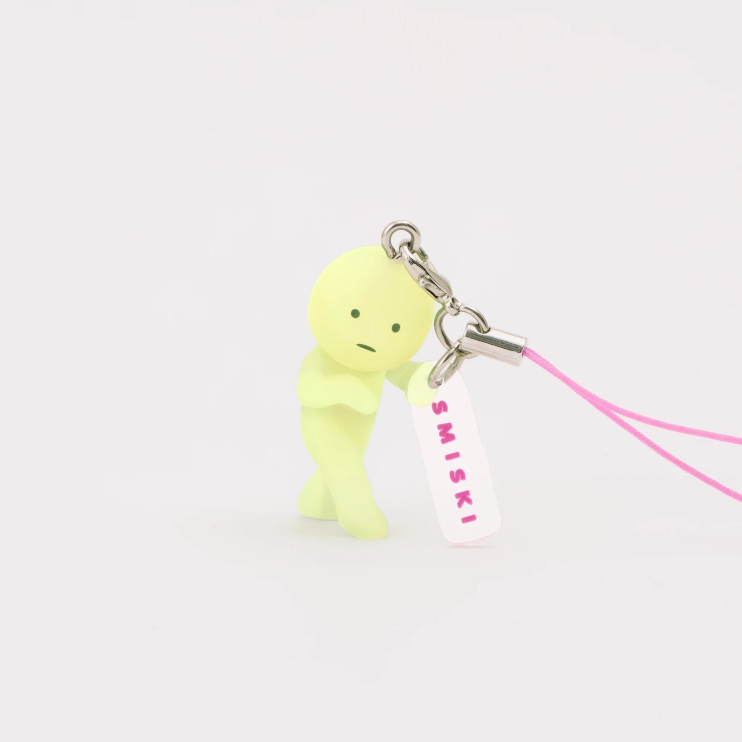 Light green Smiski strap keychain figure with pink cord and hanging SMISKI tag