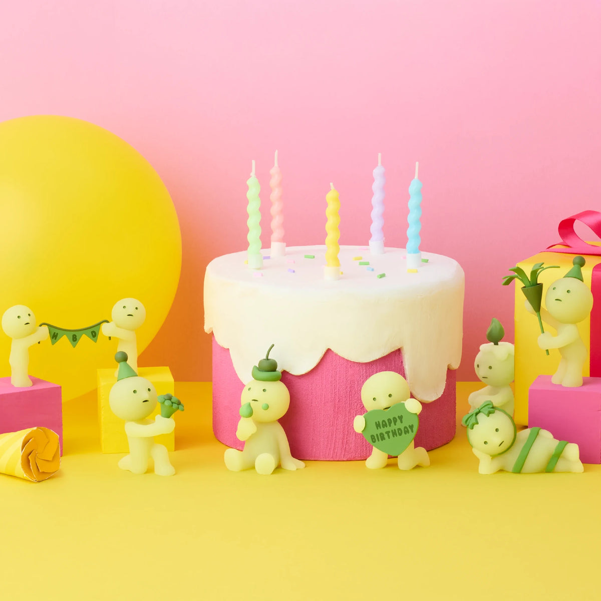 Smiski birthday blind box figure group beside frosted cake with candles