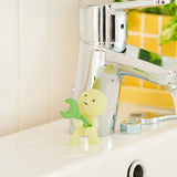 Smiski construction figure in front of chrome tool stand, light green mini figure