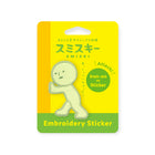 Single pale green Smiski embroidery sticker patch on bright yellow card labeled for ironing or sticking on fabric