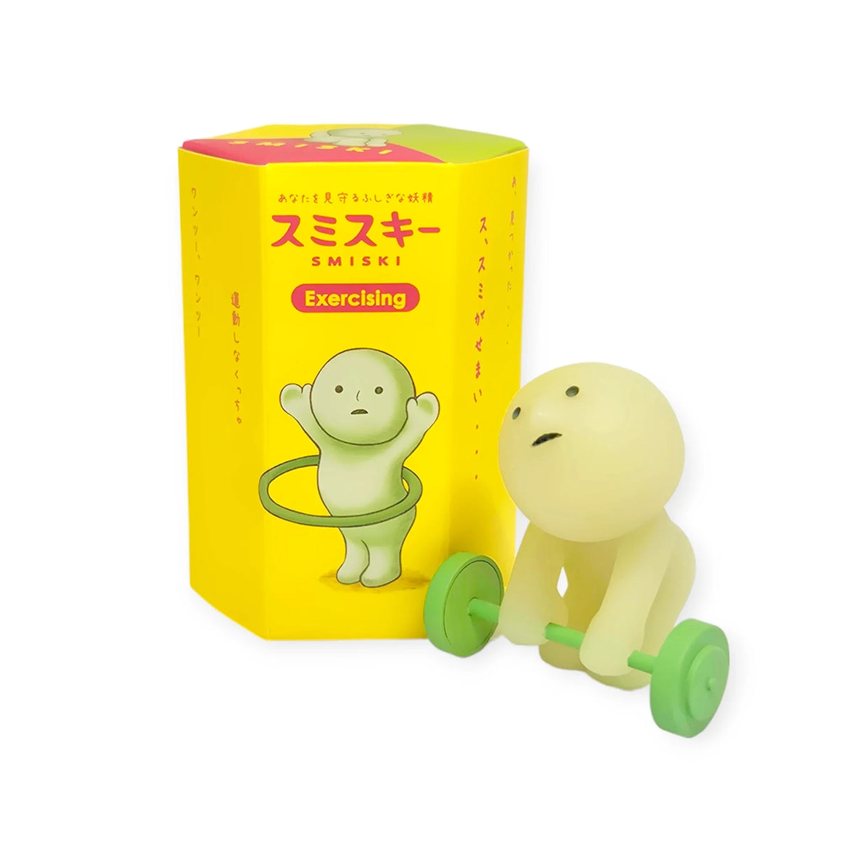 A small green character with a round head from the Smiski Exercising Series - Blind Box by Smiski is depicted lifting a barbell beside a yellow box labeled "Smiski Exercising." These glow-in-the-dark figures are perfect for adding workout inspiration to your surroundings.