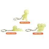 Smiski keychain figures in three poses with metal key rings