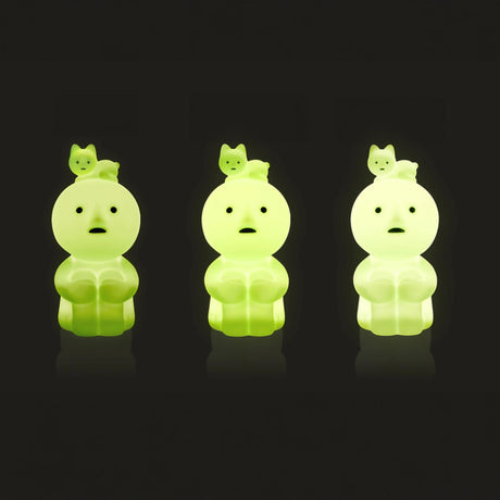 Pale green glowing hugging knees touch light figure shown in three positions