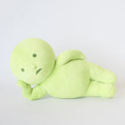 Soft green Smiski Plush figure lying on its side with neutral expression on plain white background