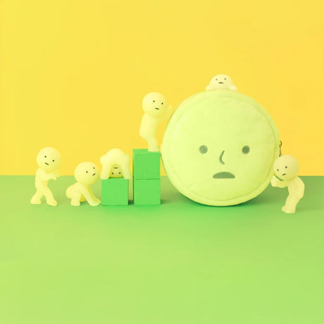 Soft round pale yellow-green pouch with simple face surrounded by six small pale yellow humanoid figures on green and yellow background