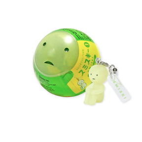 Mini Smiski glow-in-the-dark figure keychain with round green capsule packaging from Series 1 collection