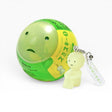Green character strap keychain with small figure and white label tag