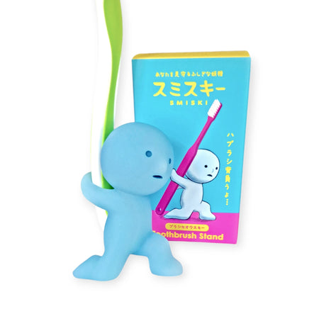 Toothbrush stand with Smiski carrying figure holding pink toothbrush, blue