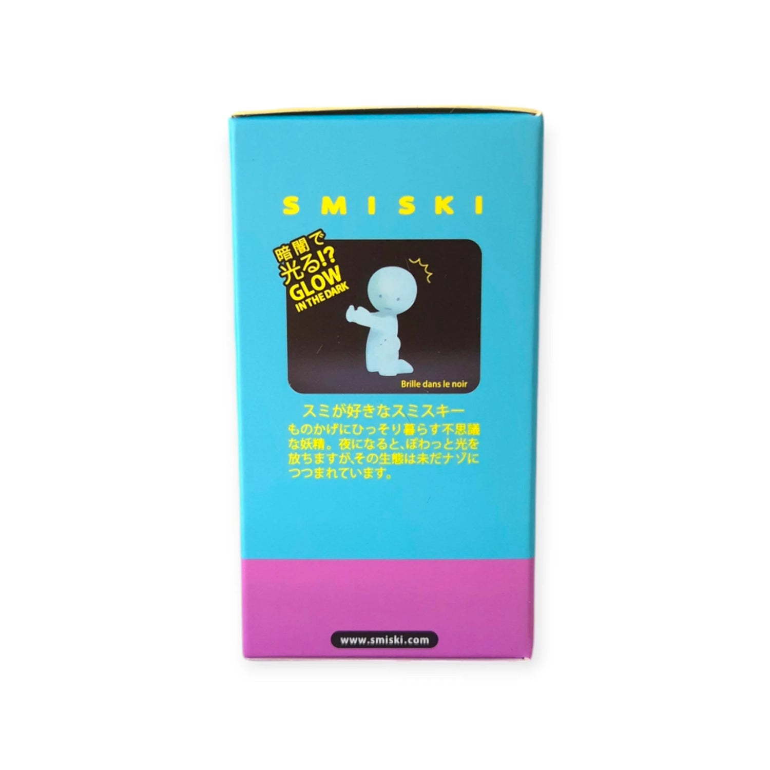 A blue and purple box displays a glowing figure illustration, with text in both English and Japanese. The brand name "Smiski" is prominently featured, providing a glimpse into the delightful world of collectible figures such as the Smiski Toothbrush Holder - Hugging Figure that glows in the dark.