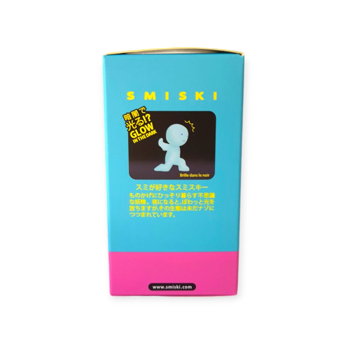 The Smiski Toothbrush Holder - Carrying Figure is packaged in blue and pink with an image of a glowing figure. It features Japanese text and the message "Glow in the Dark," highlighting its phosphorescent material.