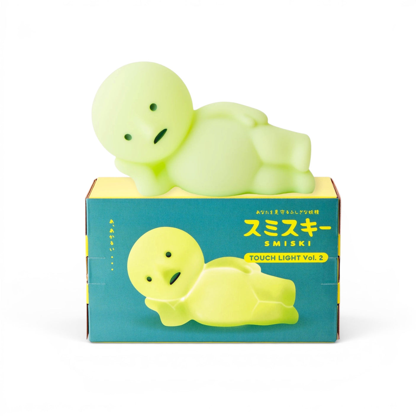 Smiski Touch Light lounging figure, light green, resting on product box