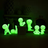 Smiski Yoga Series - Blind Box figurines by Smiski, featuring calming yoga poses, sit and stand on a dark surface, creating an illuminated glow-in-the-dark display.