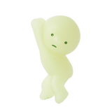 A Smiski ZipperBite - Hanging On, a green, featureless humanoid figure from Smiski, strikes a playful pose with its Glow in the Dark effect making it stand out.