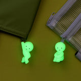 Two neon green hanging zipper bite figures on green fabric zipper pouches
