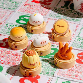 Five Smoko Dim Sum Friends blind box vinyl figures with happy faces displayed on wooden trays over colorful calendar paper