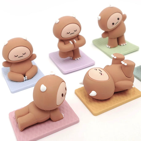 Five Smoko Hank Yeti figures in various yoga poses on pastel-colored mats against white background