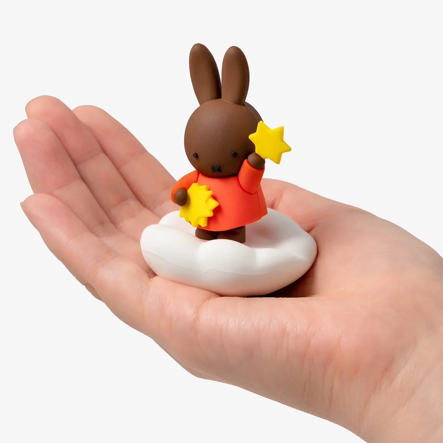 Rabbit blind box figure on cloud base with star held in orange outfit