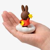 Rabbit blind box figure on cloud base with star held in orange outfit
