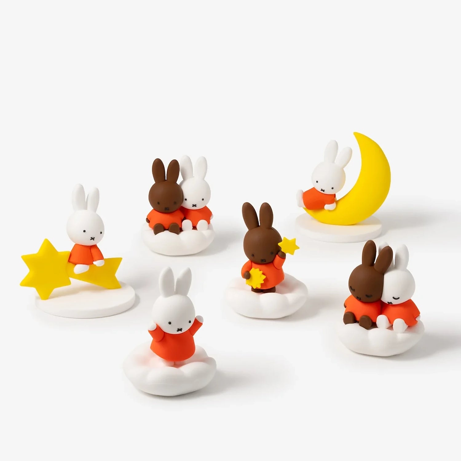 Rabbit blind box figures on white cloud bases with yellow stars and crescent moon