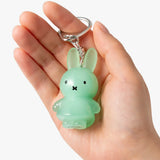 Mint green jelly rabbit keychain with metal ring and clasp, held in hand