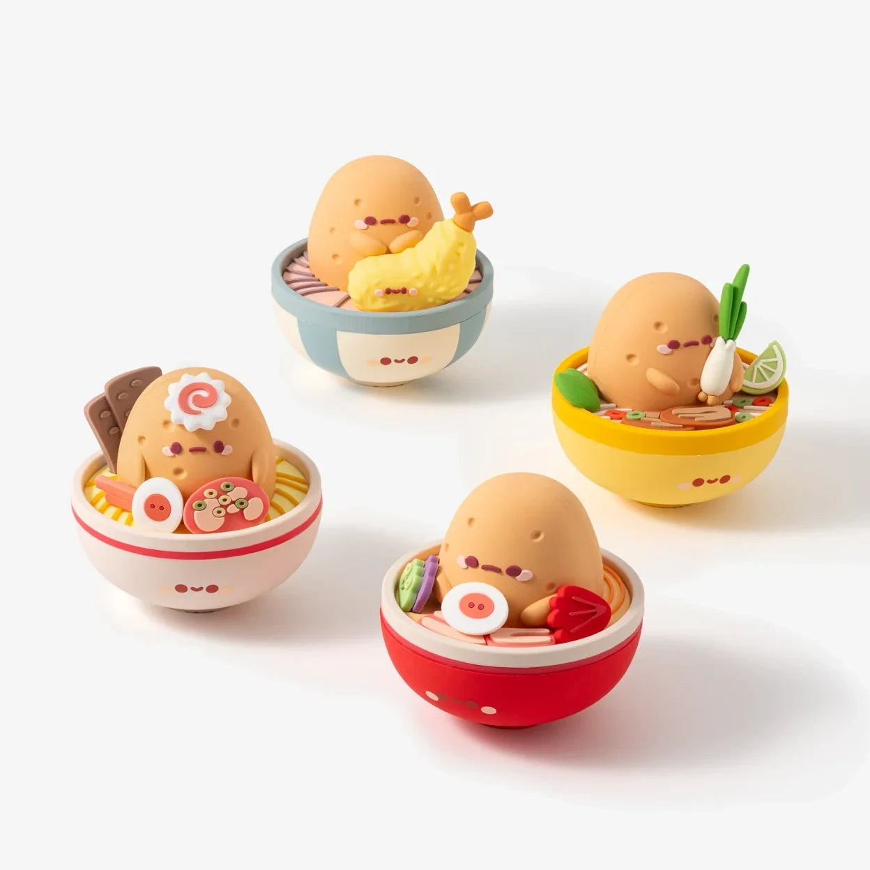 Four Smoko Tayto Ramen Blind Box vinyl figures featuring cute Tayto characters in ramen bowls with toppings.