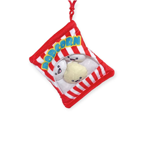 This cute Snack Bites Bag Charm by Bensons resembles a red and white popcorn bag with cartoon popcorn characters. Ideal for snack style fans, it's a fun addition to any plush toy lover's collection and part of the Snackable Plushie Bag Charms series.