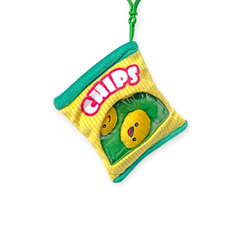 Bensons' Snack Bites Bag Charm is a plush toy resembling a chip bag with two smiling snacks set on a vibrant yellow background, accented with green trim and a convenient top loop.