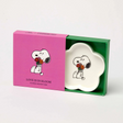 Cream flower-shaped dish with Snoopy holding flowers, in a colorful gift box