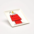 White square trinket dish tray with Snoopy and Woodstock illustration on red blanket